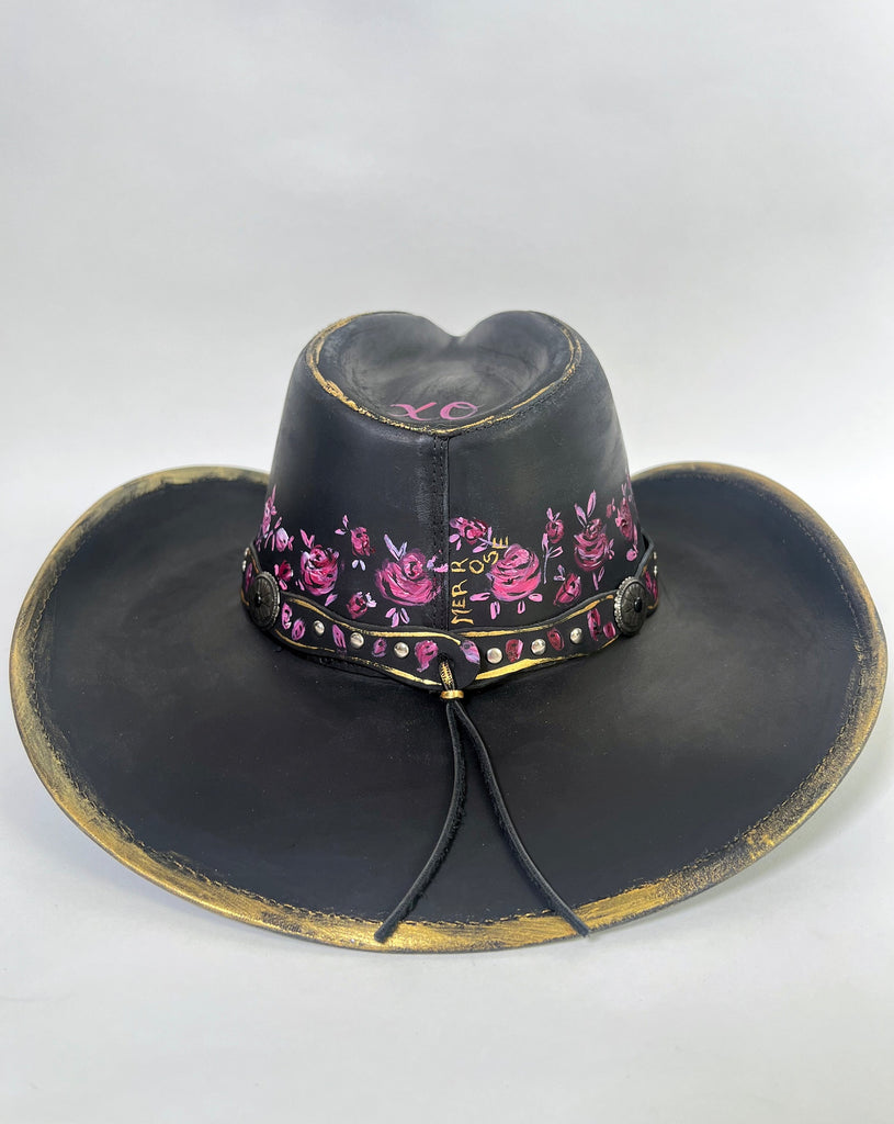 Stand out with a custom painted hat. This beauty is covered with elegant, whimsical hand painted, one-of-a-kind roses, buds and metallic gold details.