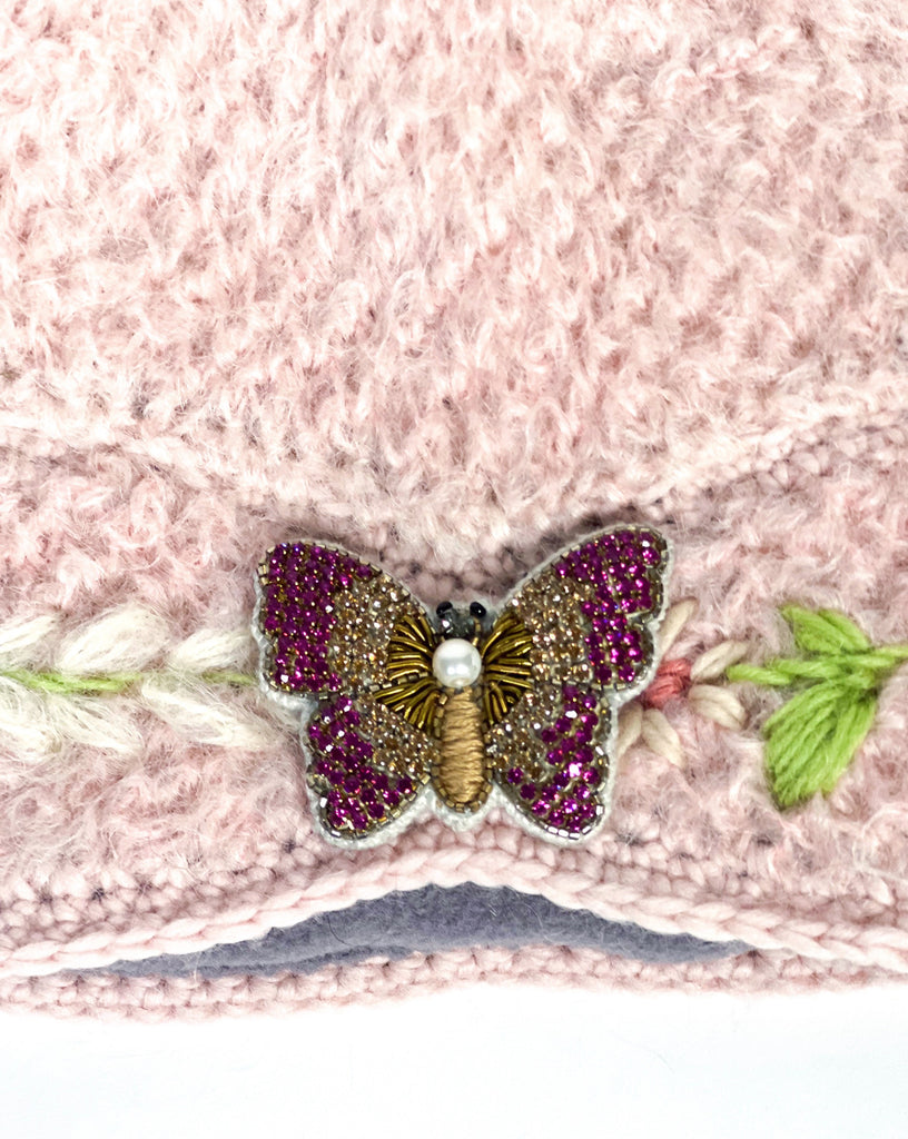Adeline hand knit cloche hat with pink butterfly brooch.